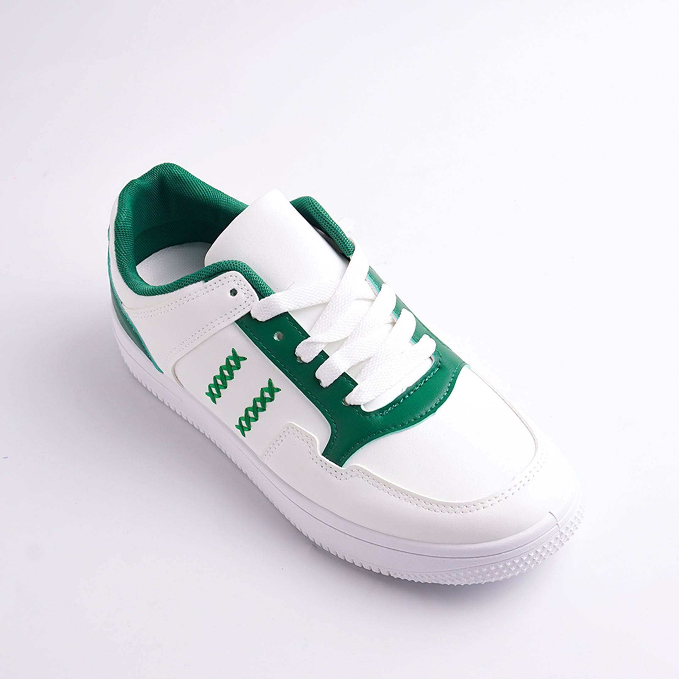 White sneaker with green accents on a white background