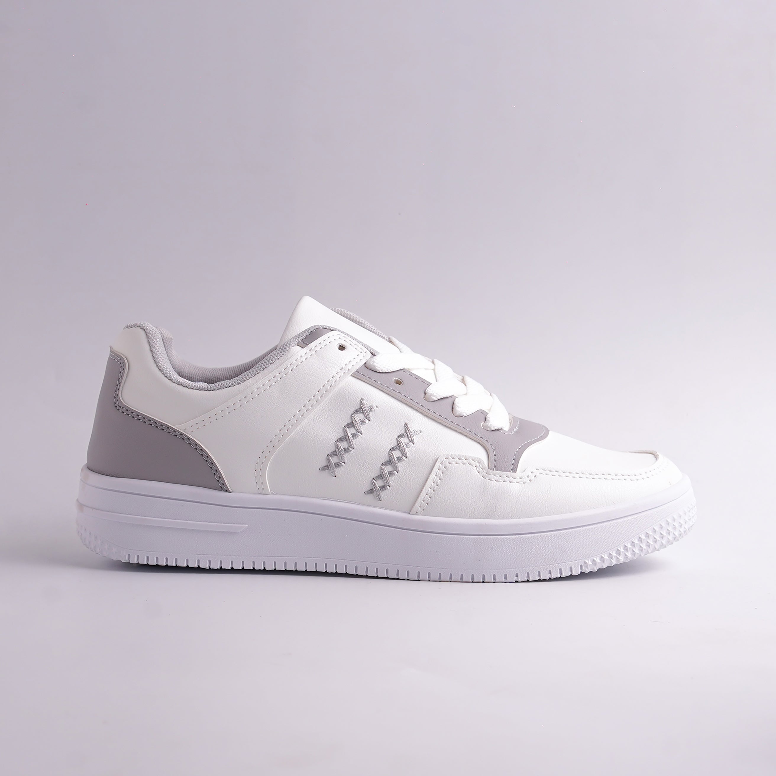 White and gray sneaker on a light gray background