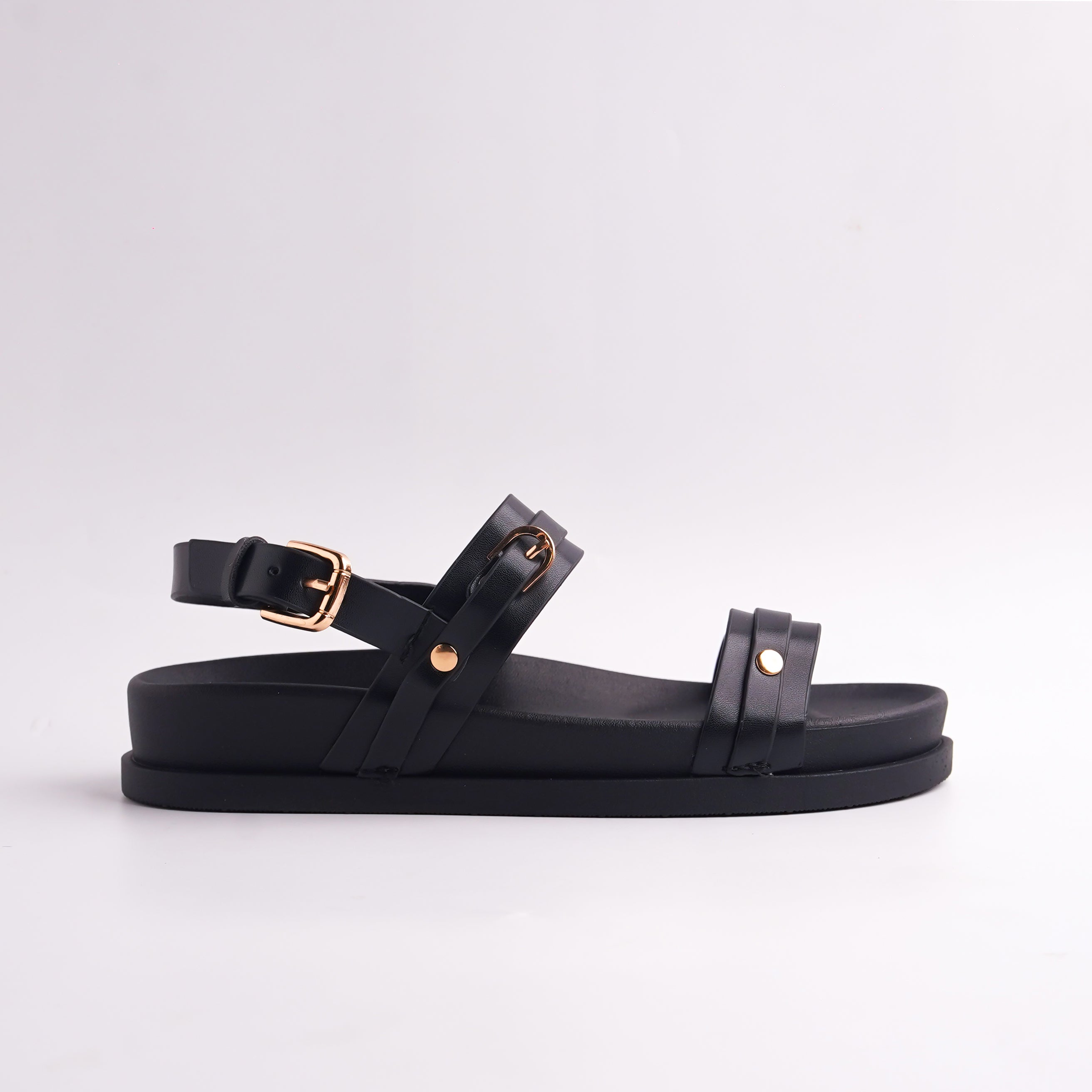 Side profile of Black Multi-Strap Ankle Flat sandal showing the gold buckle closure.