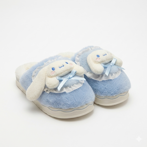 Pair of blue slippers with plush bunny design on a white background