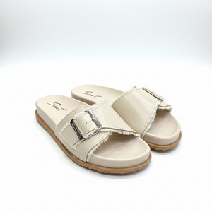 Pair of beige sandals with a buckle on a white background