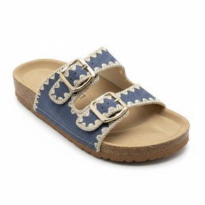 Blue sandal with gold buckles on a white background