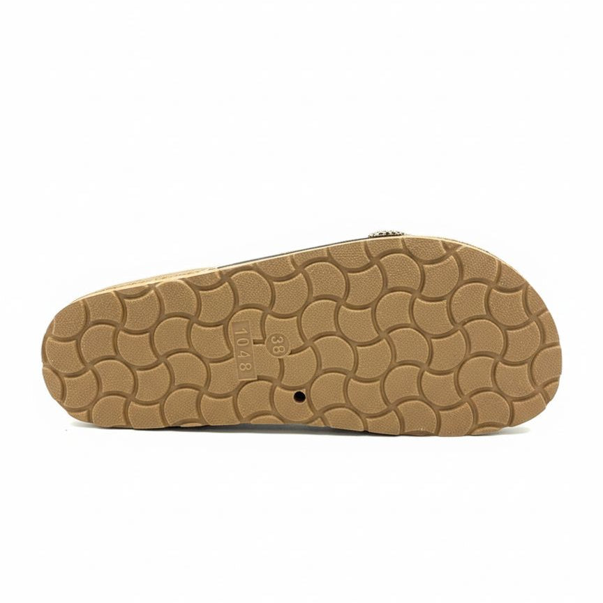 Tan sandal sole with wavy pattern on a white background